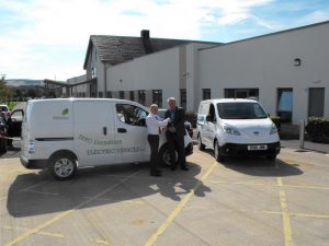 Jim Rowan, EV specialist at Alex F Noble & Son (left) handing over the keys of the e-NV200 vans to Brian Robb, area soft FM manager at NHS Lothian